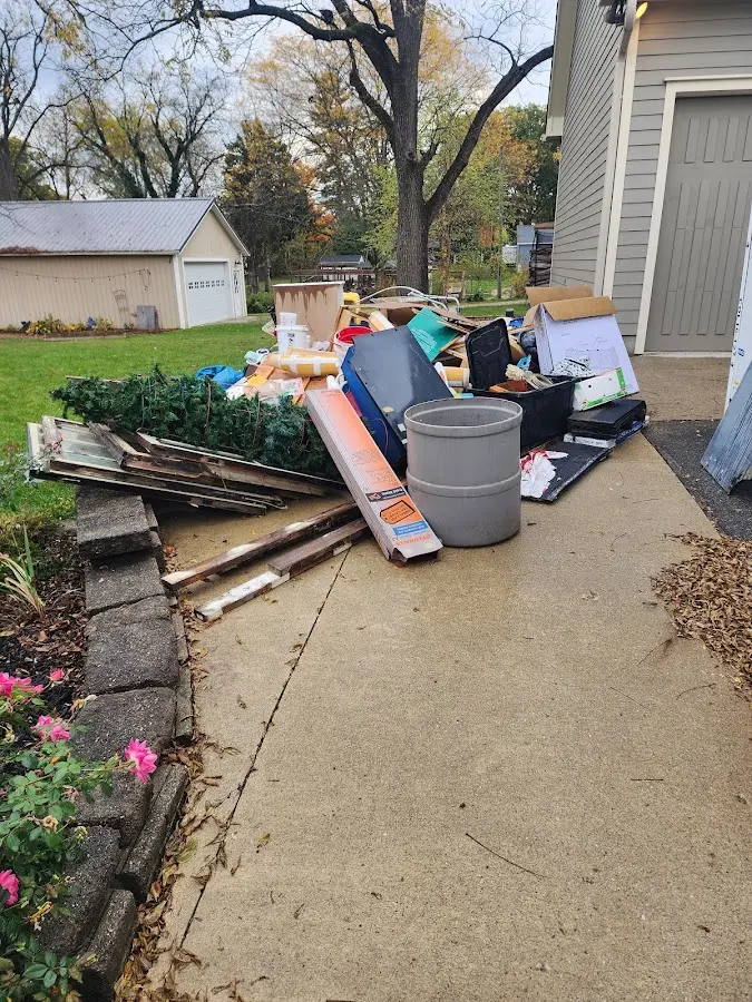 Dumpster being loaded with debris for Roofing Dumpster Rental in Byrnes Mill